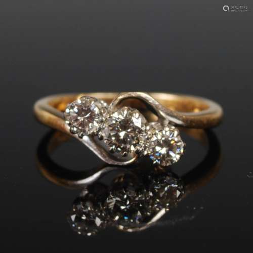A yellow and white metal three stone diamond ring, mid 20th ...