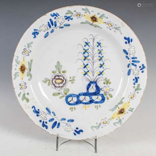 An 18th century Delft charger, decorated with garden of peon...