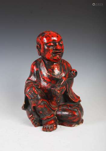 A Chinese carved camphor wood and red lacquered figure of a ...