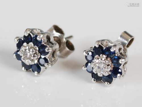 A pair of white metal sapphire and diamond set cluster earri...