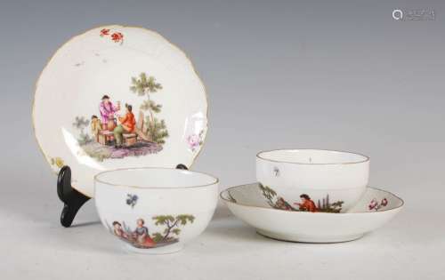 A pair of Meissen porcelain tea cups and saucers, painted wi...