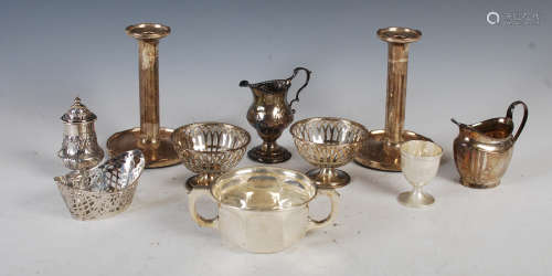 A collection of silver, to include; a pair of candlesticks, ...