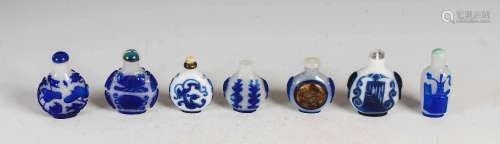 A collection of seven Chinese blue glass overlay snuff bottl...