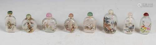 A collection of eight Chinese inside painted glass snuff bot...