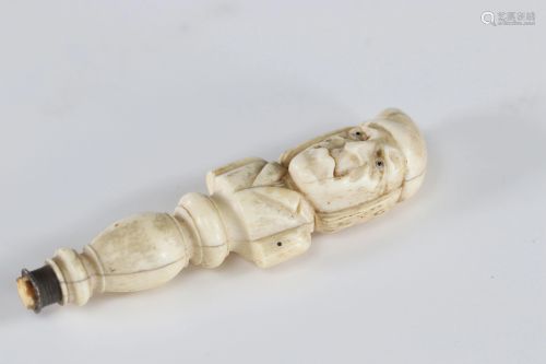 Curiosity handle carved with a grotesque character