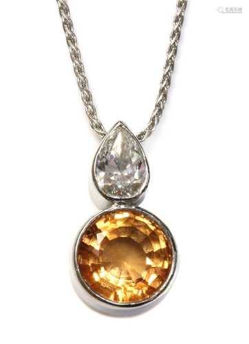 An 18ct white gold topaz and diamond pendant,