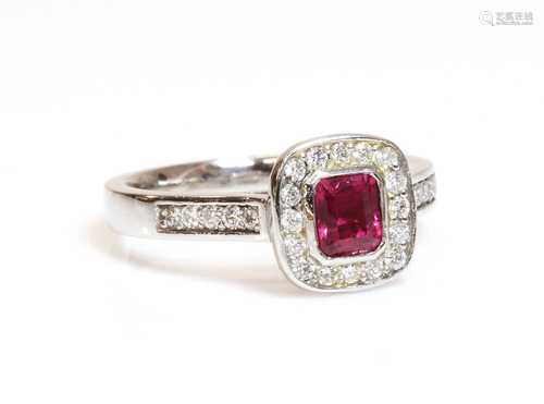 A platinum, ruby and diamond cushion shaped halo cluster rin...