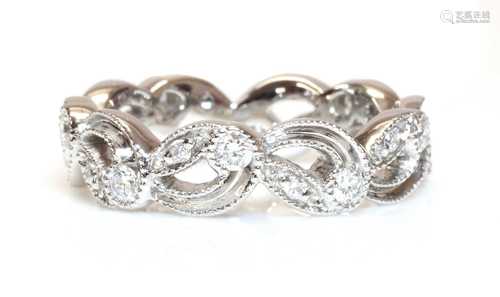 An 18ct white gold pierced diamond set band ring,