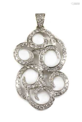 A white gold diamond set scrolling pendant,