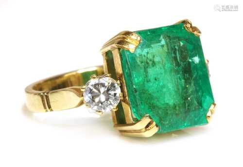 An emerald and diamond three stone ring,