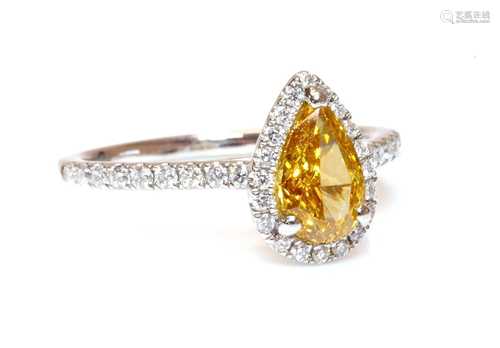 A platinum fancy orange-yellow diamond and diamond halo clus...