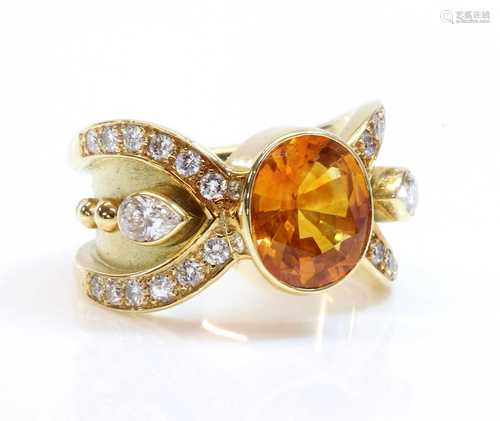 A golden yellow sapphire and diamond band ring,