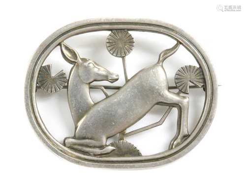 A sterling silver kneeling deer brooch, by Georg Jensen,