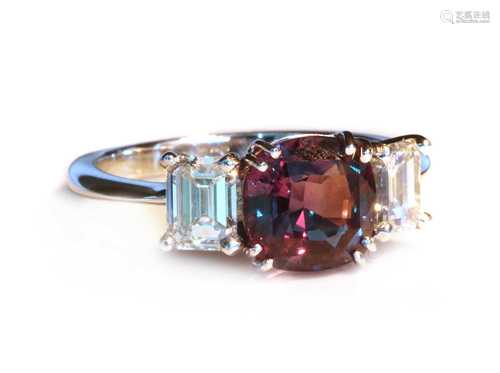 A white gold three stone colour change alexandrite and diamo...