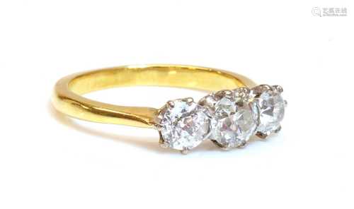 A gold three stone diamond ring,