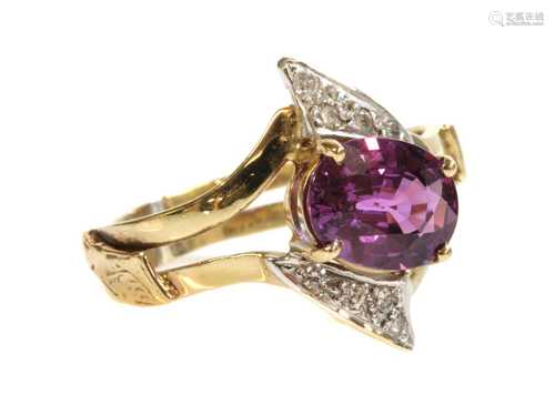 A gold single stone pink sapphire and diamond crossover ring...