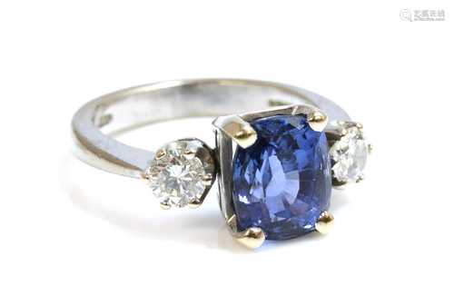 An 18ct white gold three stone sapphire and diamond ring,