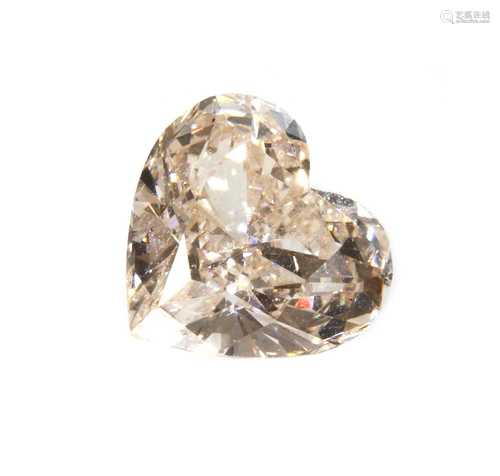 An unmounted fancy yellowish pink heart shaped brilliant cut...