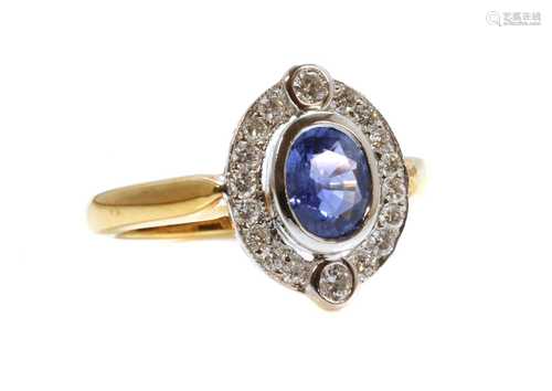 An 18ct yellow and white gold sapphire and diamond oval clus...