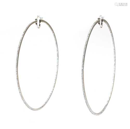 A pair of large white gold diamond set hoop earrings,