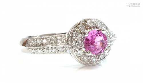 An 18ct white gold pink sapphire and diamond halo cluster ri...