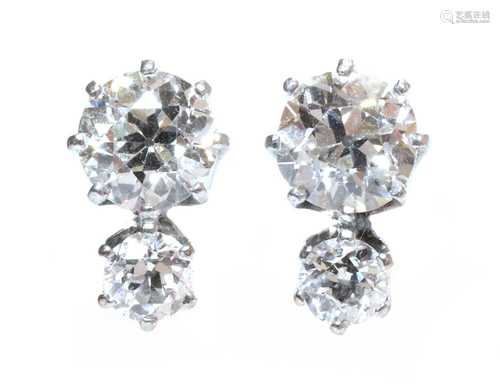 A pair of two stone diamond stud earrings,