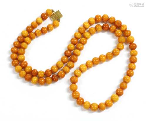 A single row uniform spherical butterscotch amber bead neckl...