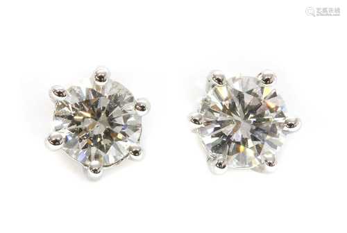 A pair of single stone diamond stud earrings,