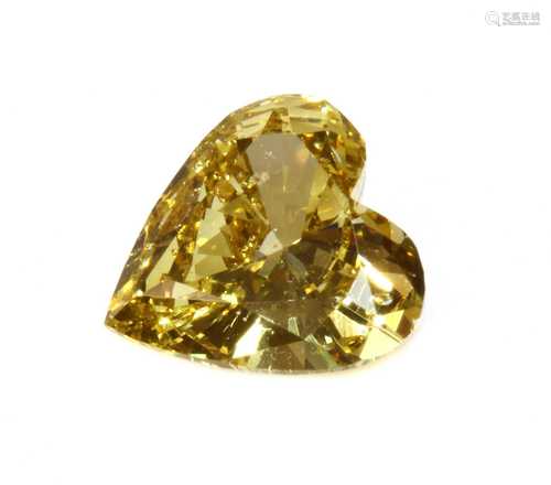 An unmounted fancy yellow heart shaped brilliant cut diamond...