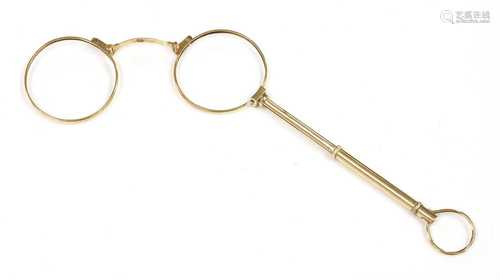 A pair of gold lorgnettes,