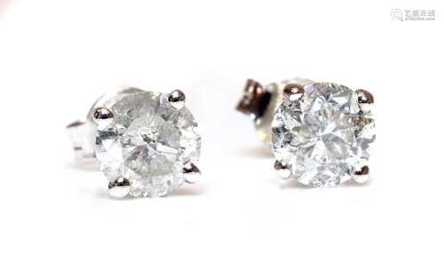 A pair of white gold single stone diamond earrings,