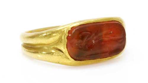 A high carat gold carved cornelian intaglio ring,