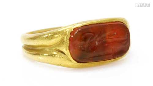 A high carat gold carved cornelian intaglio ring,