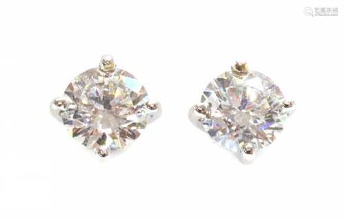 A pair of white gold single stone diamond earrings,