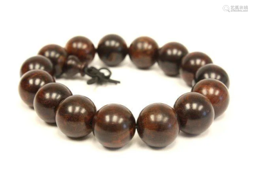 A string of HUANGHUALI Brown BEADS