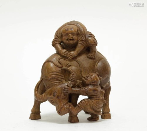 A Carved Bamboo Buffalo and two boys