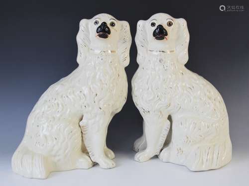 A large pair of Victorian Staffordshire glass eyed spaniels,...