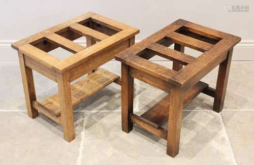 A pair of honey oak luggage stands, 20th century, each with ...