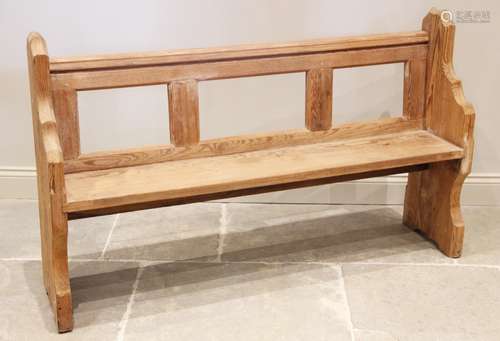 A Victorian pitch pine pew, the rail back above a board seat...