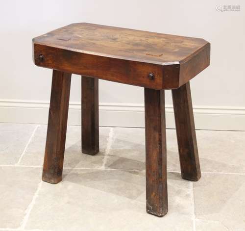 An early 20th century elm butchers block type table, the rec...