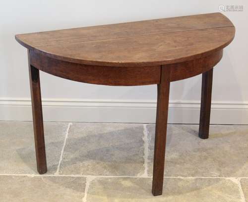 A George III honey oak D end side table, the bow front top r...