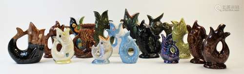 A collection of novelty glug jugs, to include dolphin's mask...