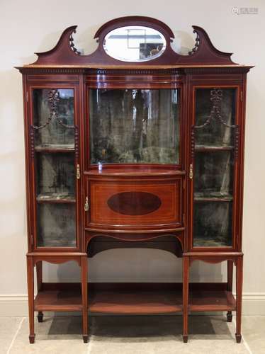 An Edwardian inlaid mahogany display cabinet, the mirrored p...