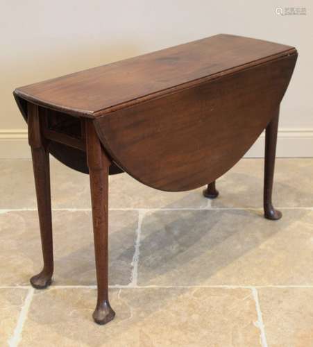 A George III mahogany drop leaf table, the oval top on cylin...