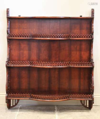 A reproduction stained hardwood wall shelf, the three break ...