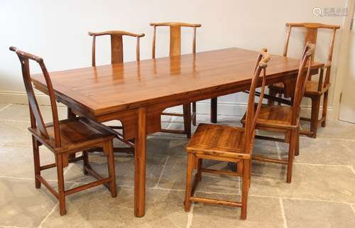 A Chinese elm dining table with six associated chairs, secon...