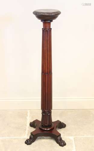 A 19th century mahogany torchere, the 25cm top with a carved...