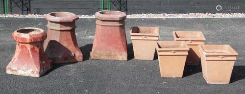 A set of four terracotta stone planters, each of tapering sq...