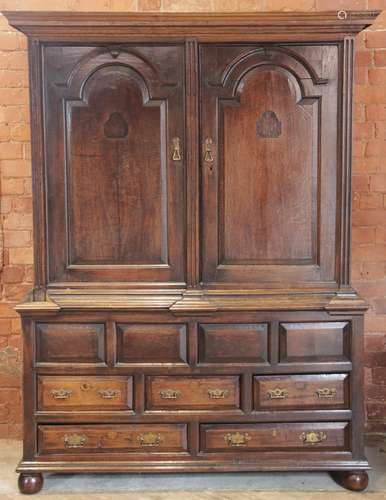 An early 18th century oak livery cupboard, the moulded corni...