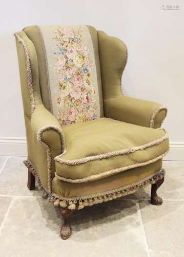 A George II style wing back fireside armchair, early 20th ce...